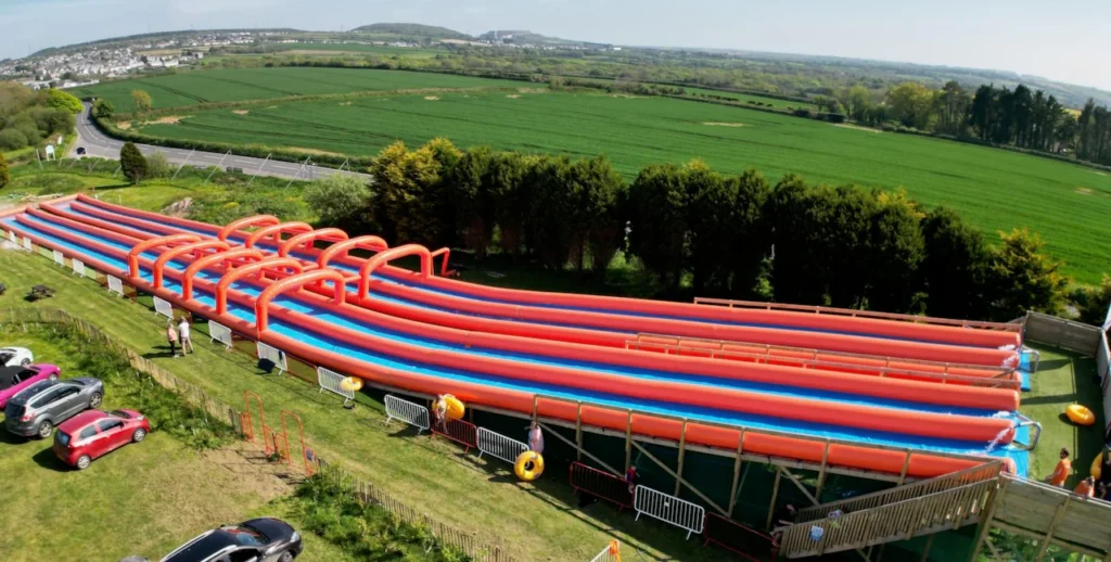 Aerial view of the giant inflatable slides at Cornwall Slip and Slide, Atlantic Reach Resort near Newquay